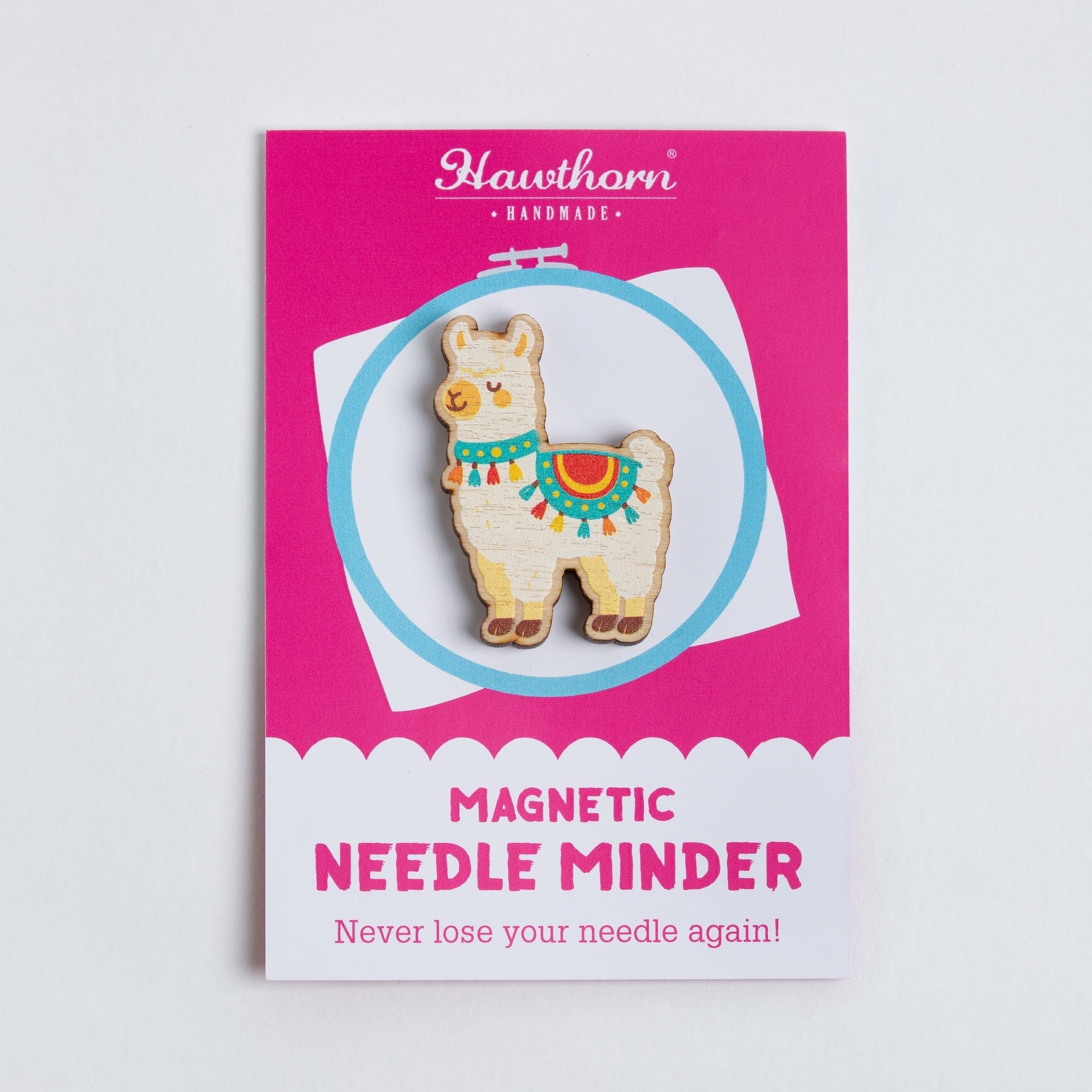 Magnetic needle minder with Alpaca design on a pink card against a light gray background