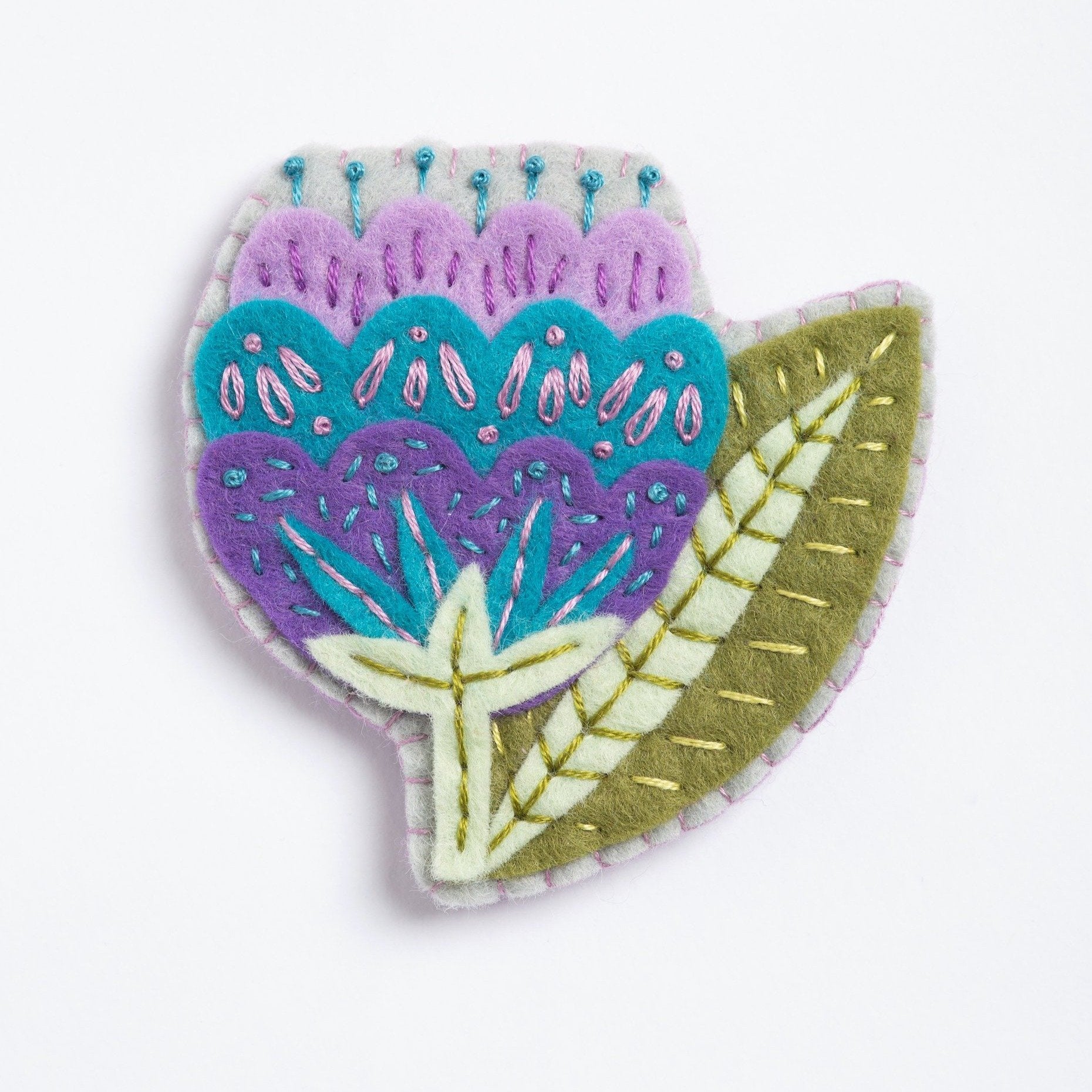 Clipped image of vita flower brooch on white background.