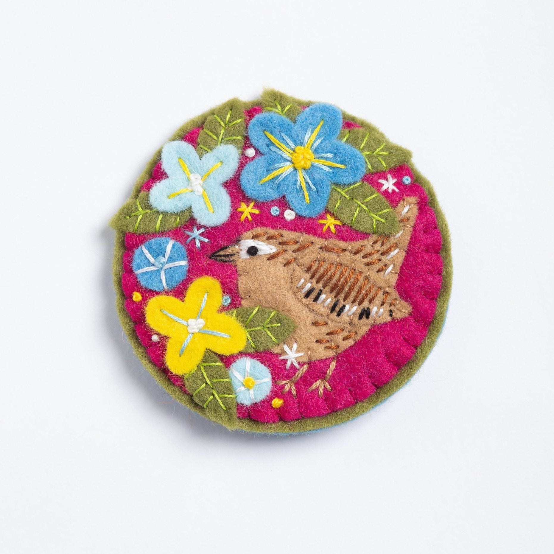 Clipped image of wren brooch on white background.