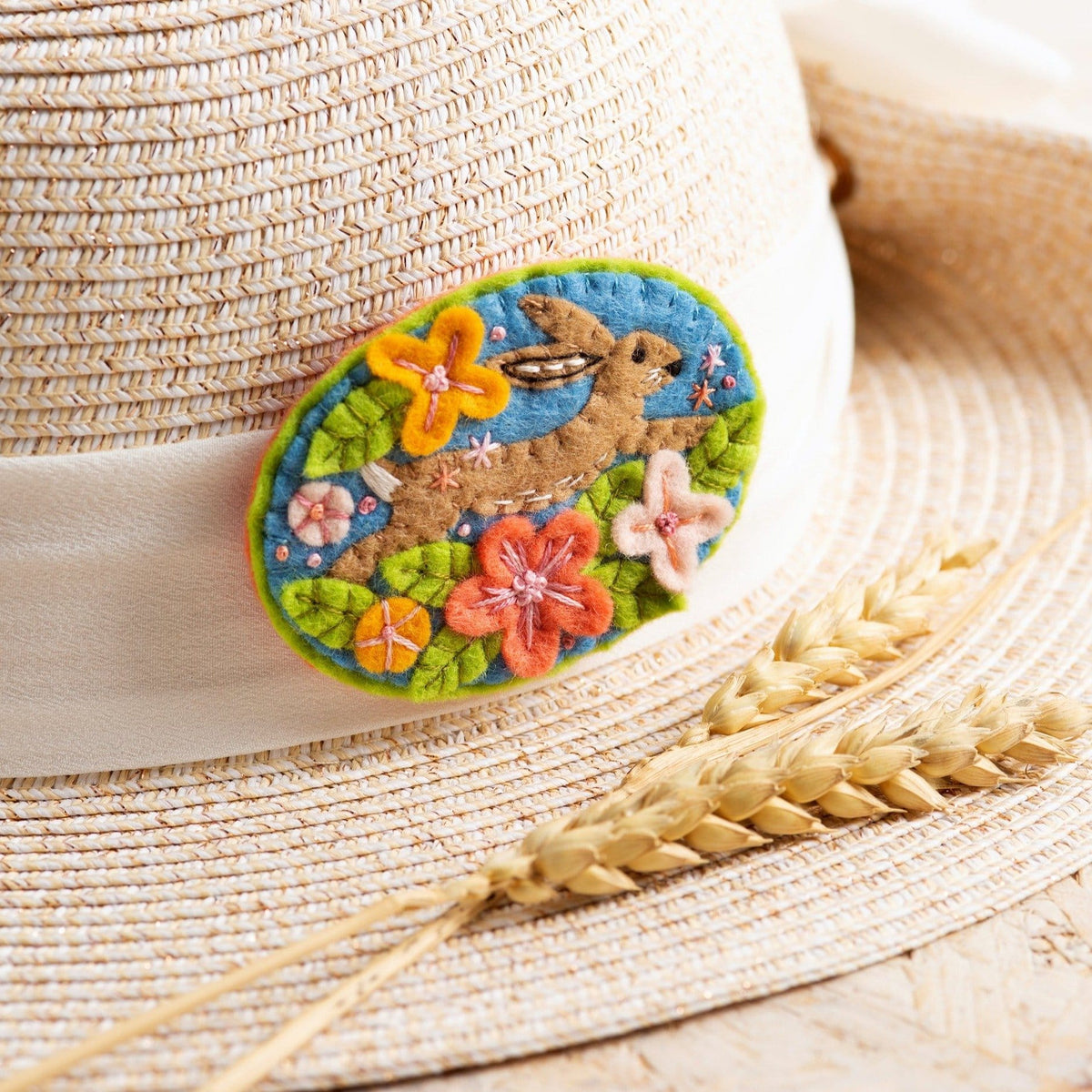 Hare brooch felt craft kit worn on side of summer hat.