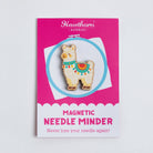 Magnetic needle minder with Alpaca design on a pink card against a light gray background