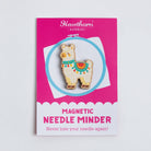 Magnetic needle minder with Alpaca design on a pink card against a light gray background