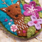 Close up image of deer brooch.