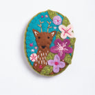 Cutout image of deer brooch on white background.