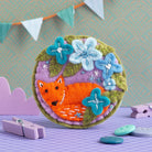 Fox brooch displayed on purple background