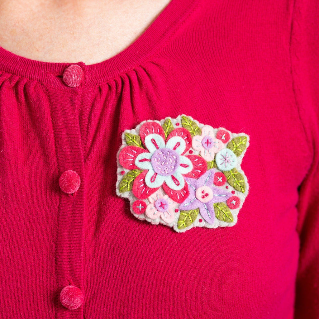 Gertrude flower brooch worn on cardigan.