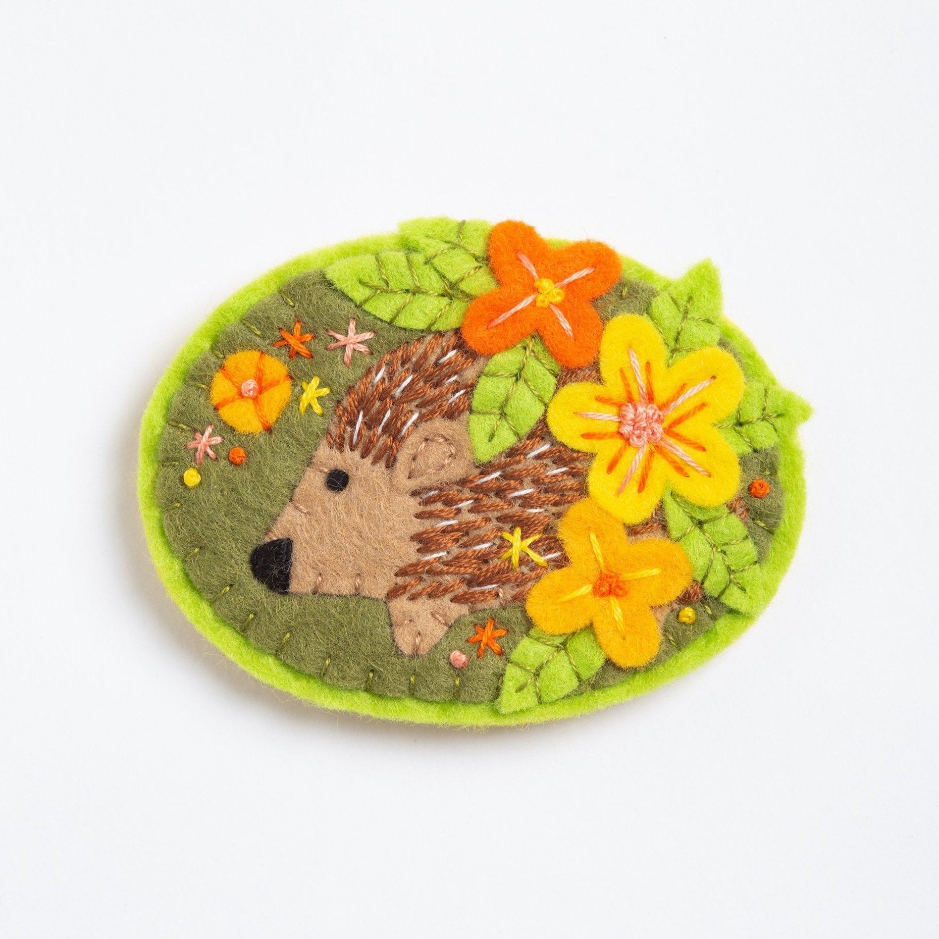 clipped image of hedgehog brooch on white background.