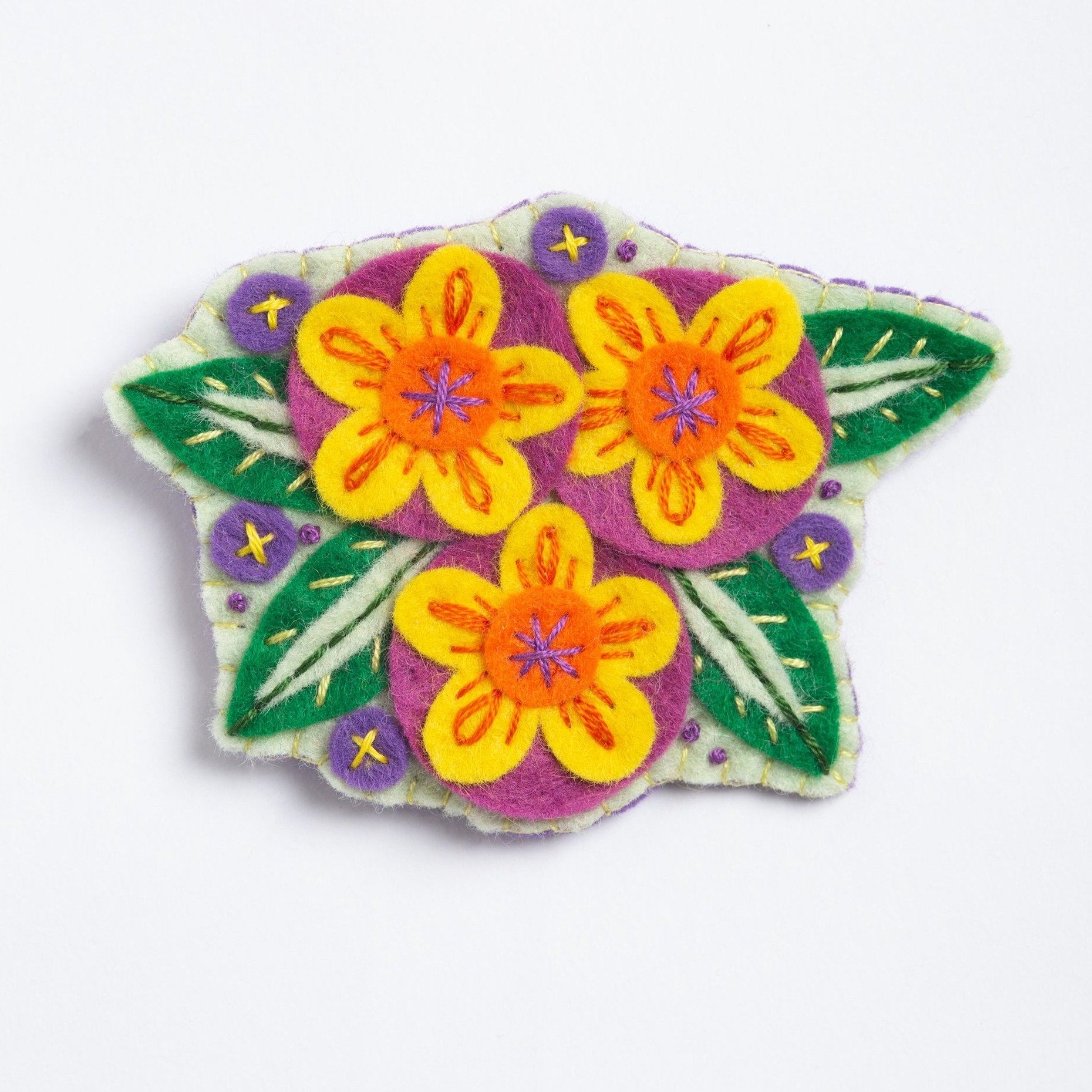 clipped image of penelope flower brooch on white background.
