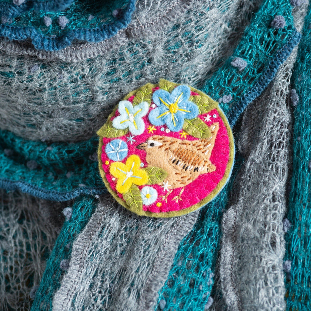 Wren brooch worn on teal, blue and grey scarf.