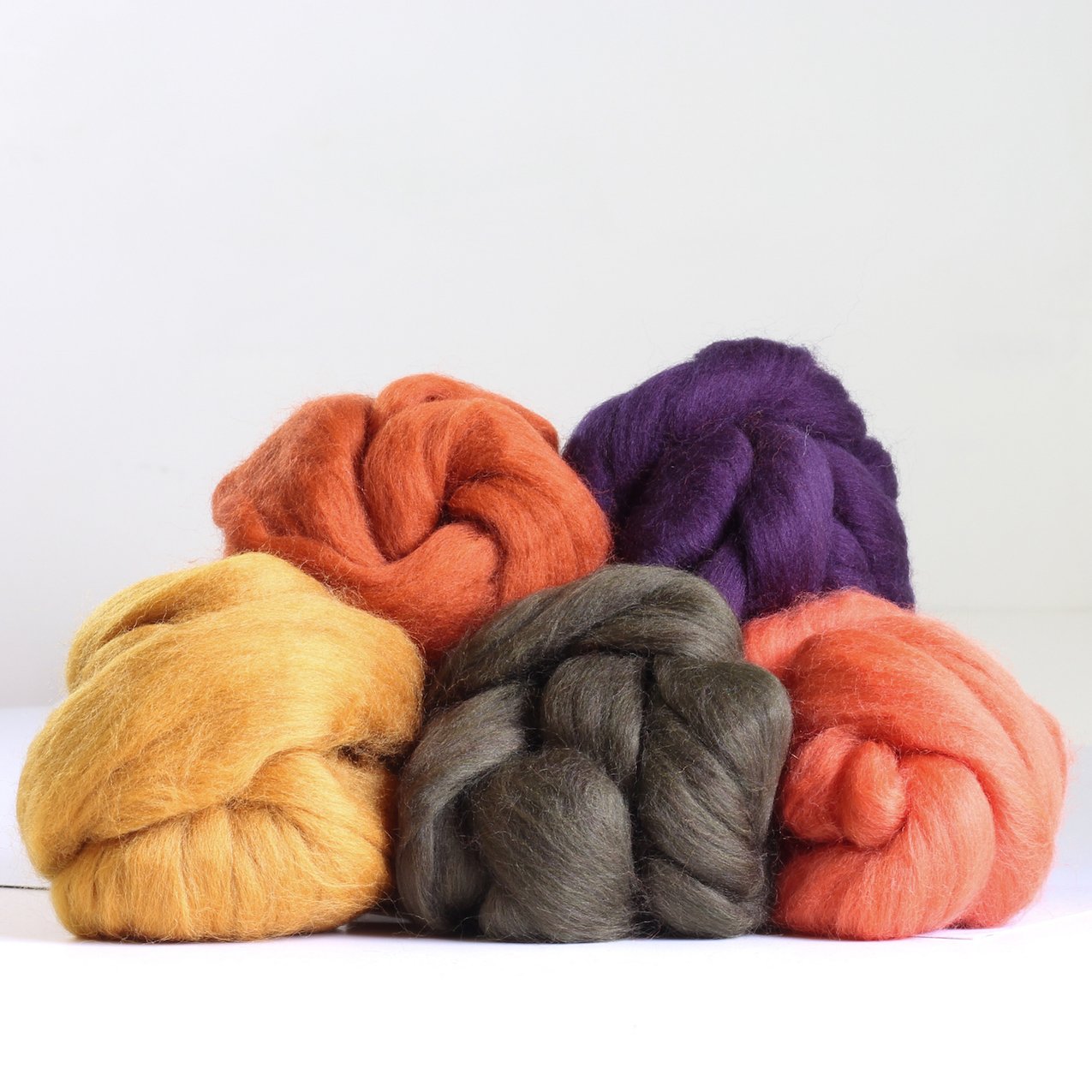 Autumn Wool Bundles piled up on a white background.