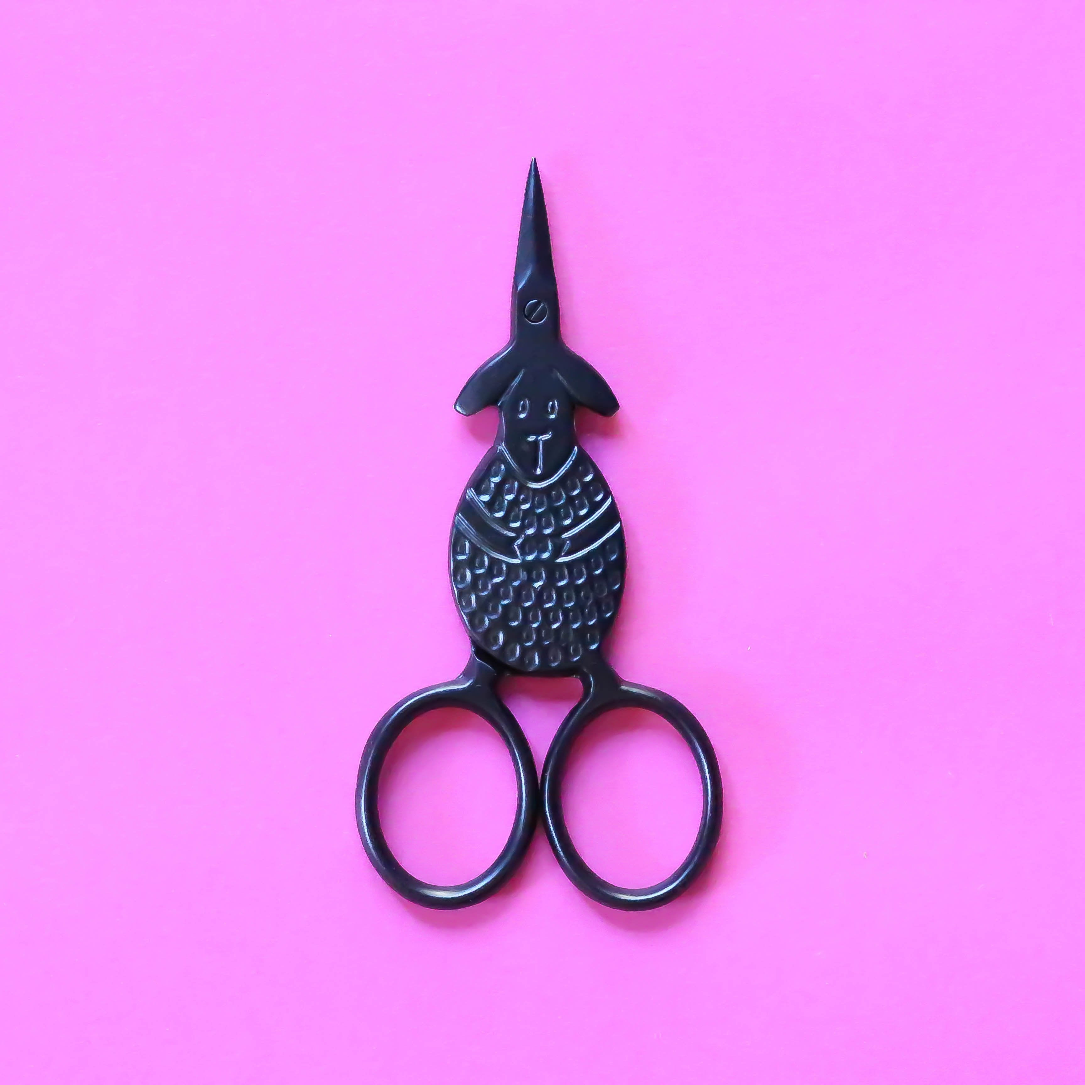 Black Sheep Embroidery Scissors closed on pink background